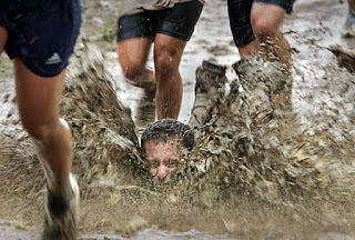 a man being chased by a mud runner