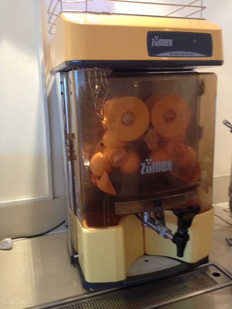 a yellow and white juice dispenser