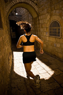 a woman running in a dark alley