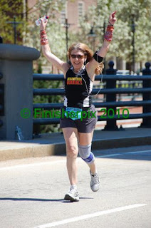 a woman running with her arms up