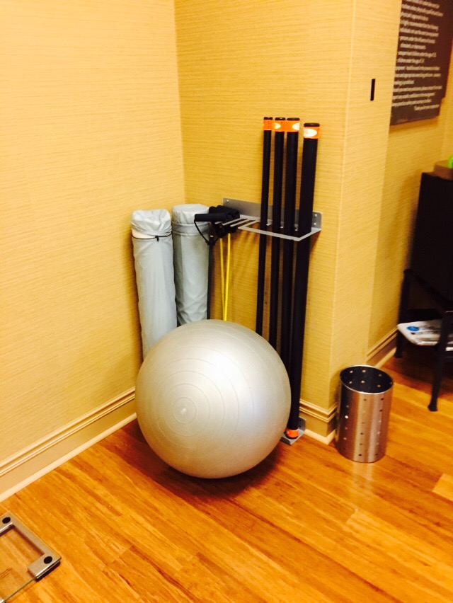 a gym ball and poles on a wood floor