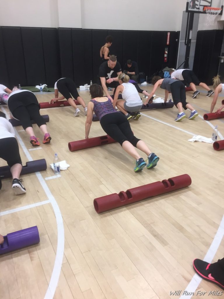 a group of people working out on foam rollers
