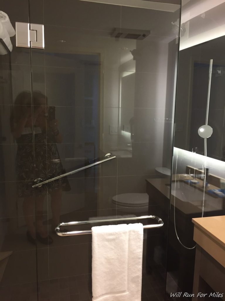 a mirror of a bathroom with a glass door