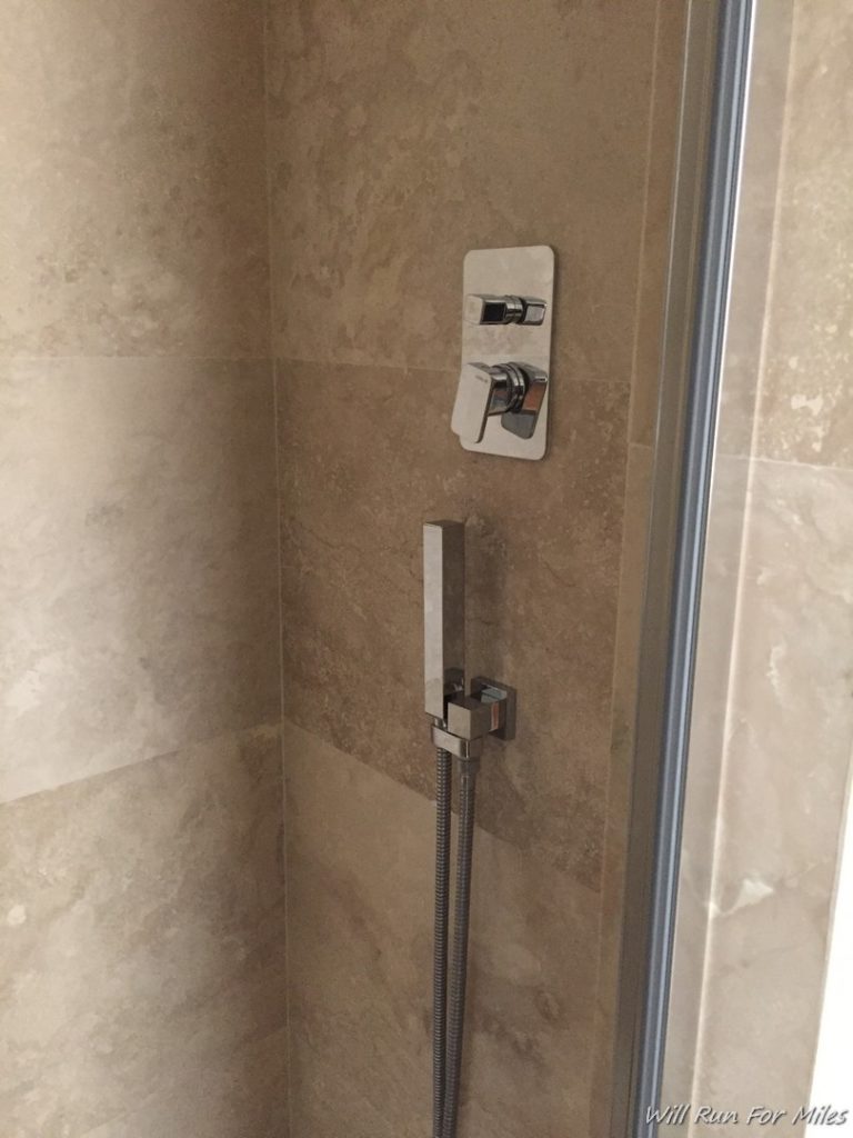 a shower head and hose in a bathroom