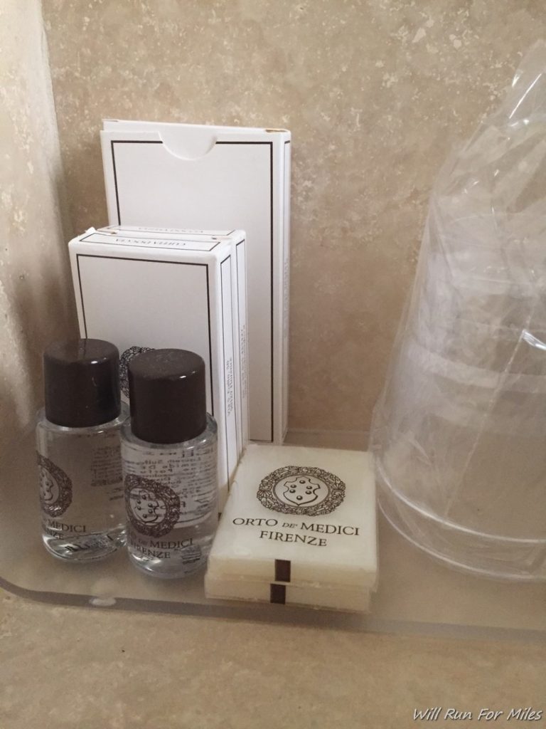 a small bottles of liquid and a box of soap