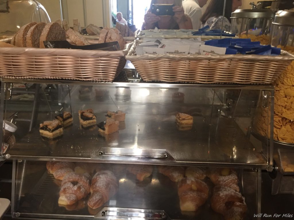 a display case with pastries and baskets