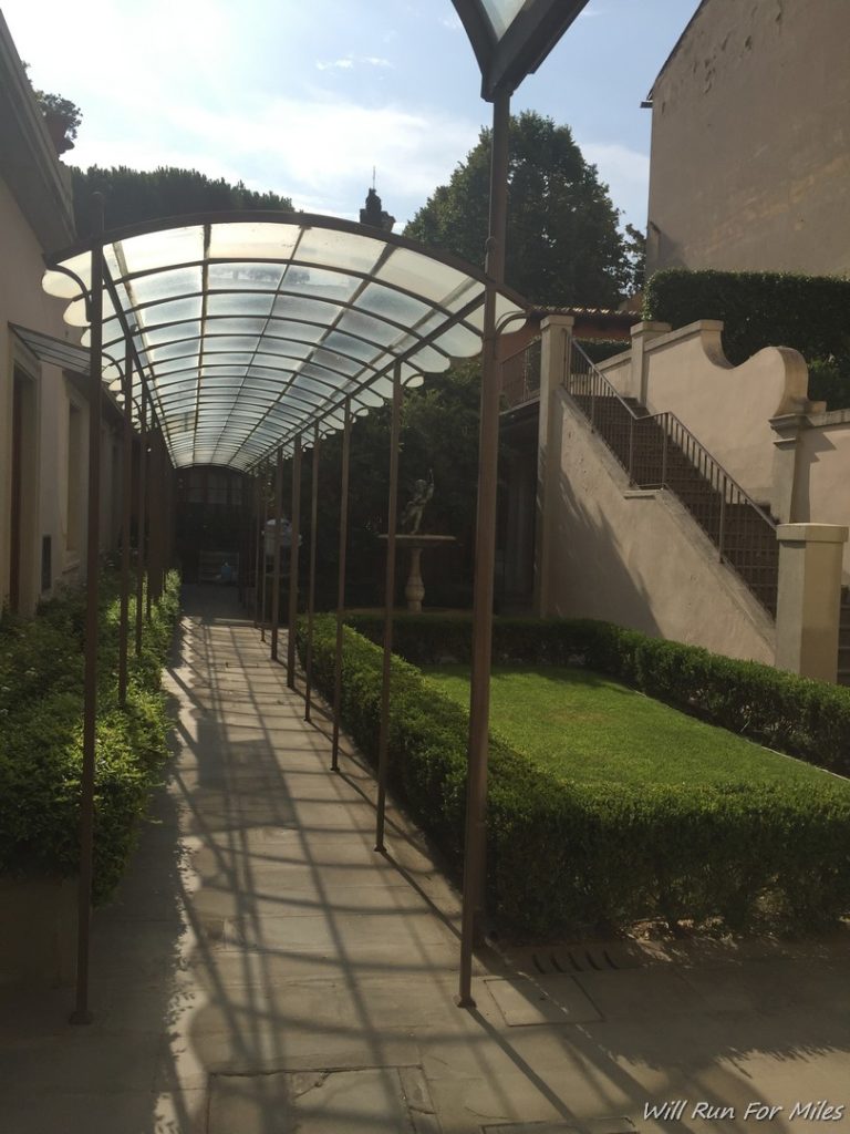 a walkway with a glass covered walkway
