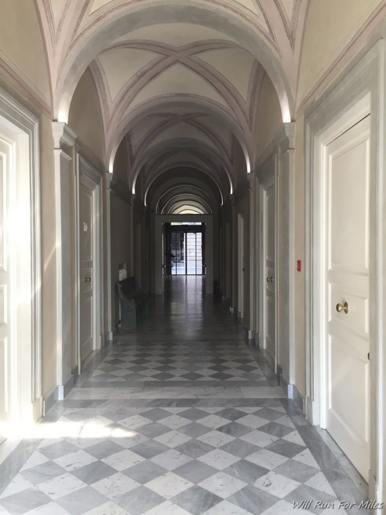 a hallway with arched ceiling and doors