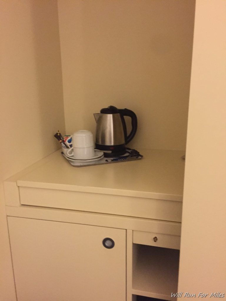 a coffee pot and cup on a counter