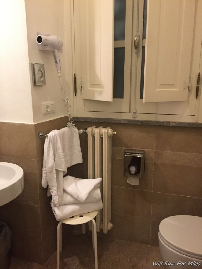 a bathroom with a towel rack and a sink