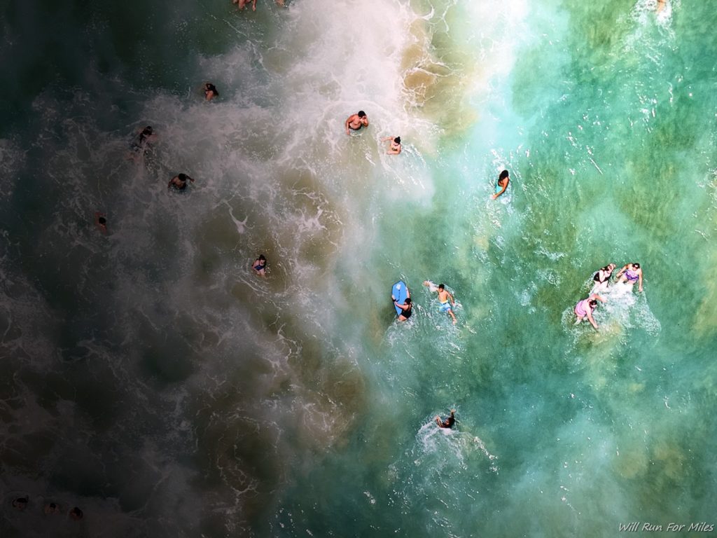 a group of people swimming in the ocean