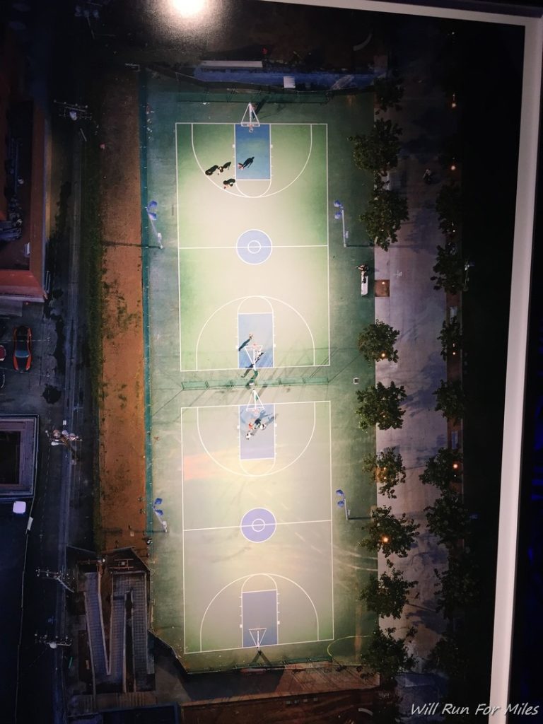 a basketball court with people playing basketball