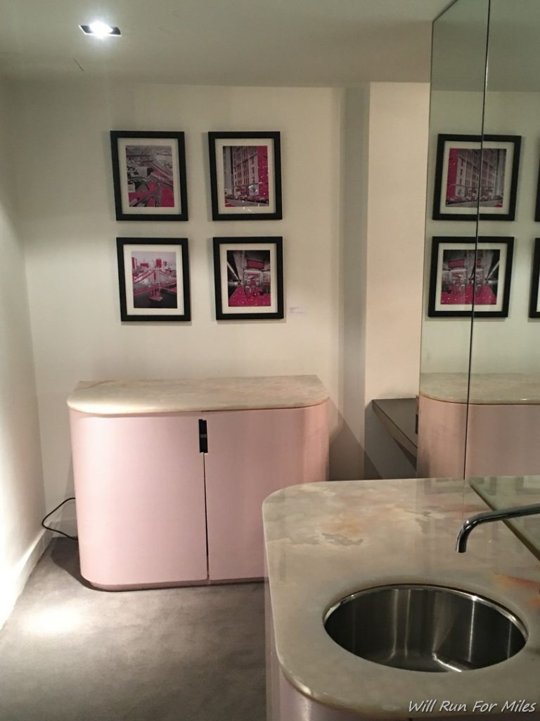 a sink and pink cabinets in a room