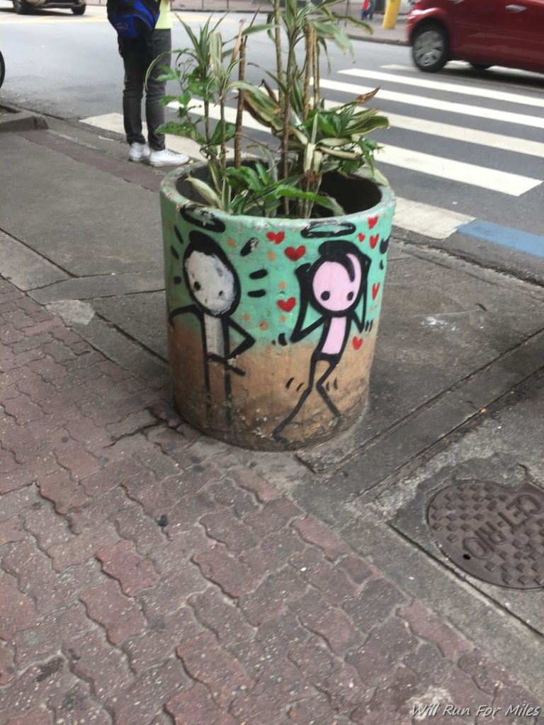 a planter with a couple of people painted on it