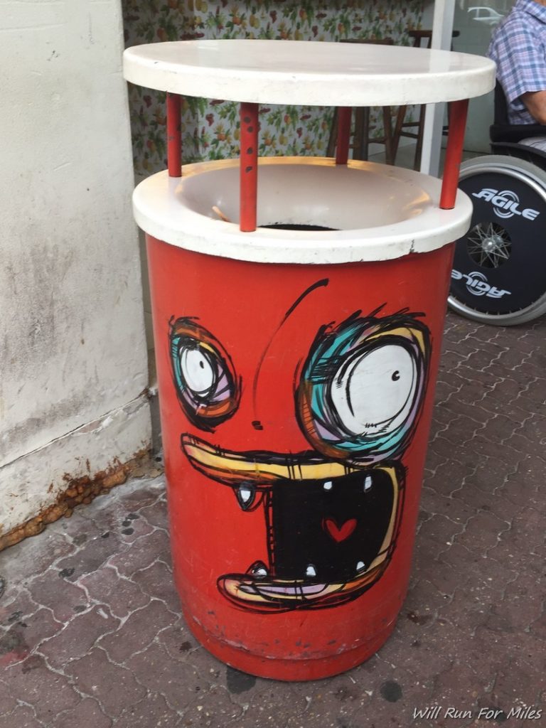 a trash can with a face drawn on it