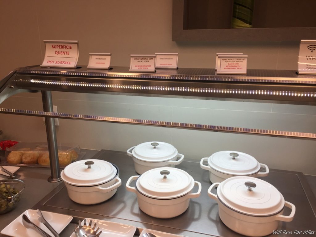 a group of white pots on a metal counter