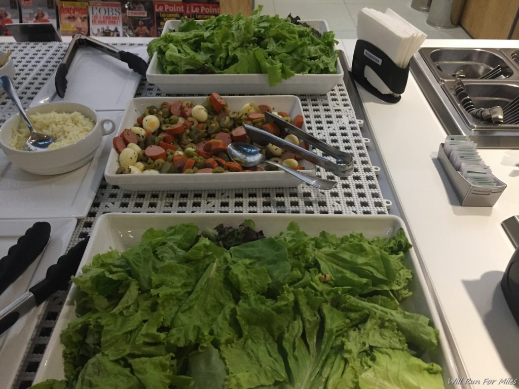 a trays of salad and other food