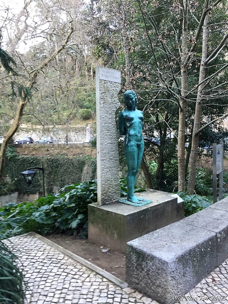 a statue of a woman standing on a stone block