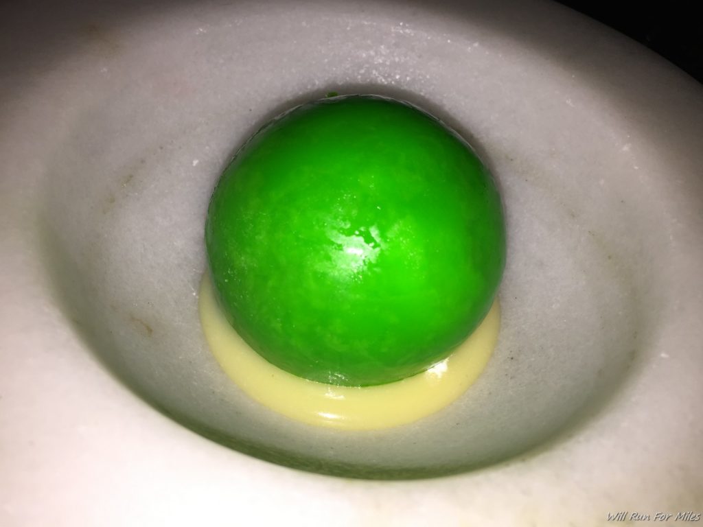 a green ball in a white bowl