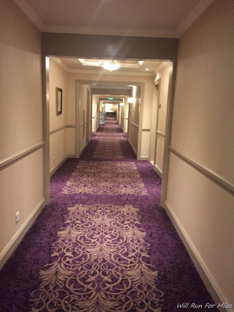 a hallway with purple carpet