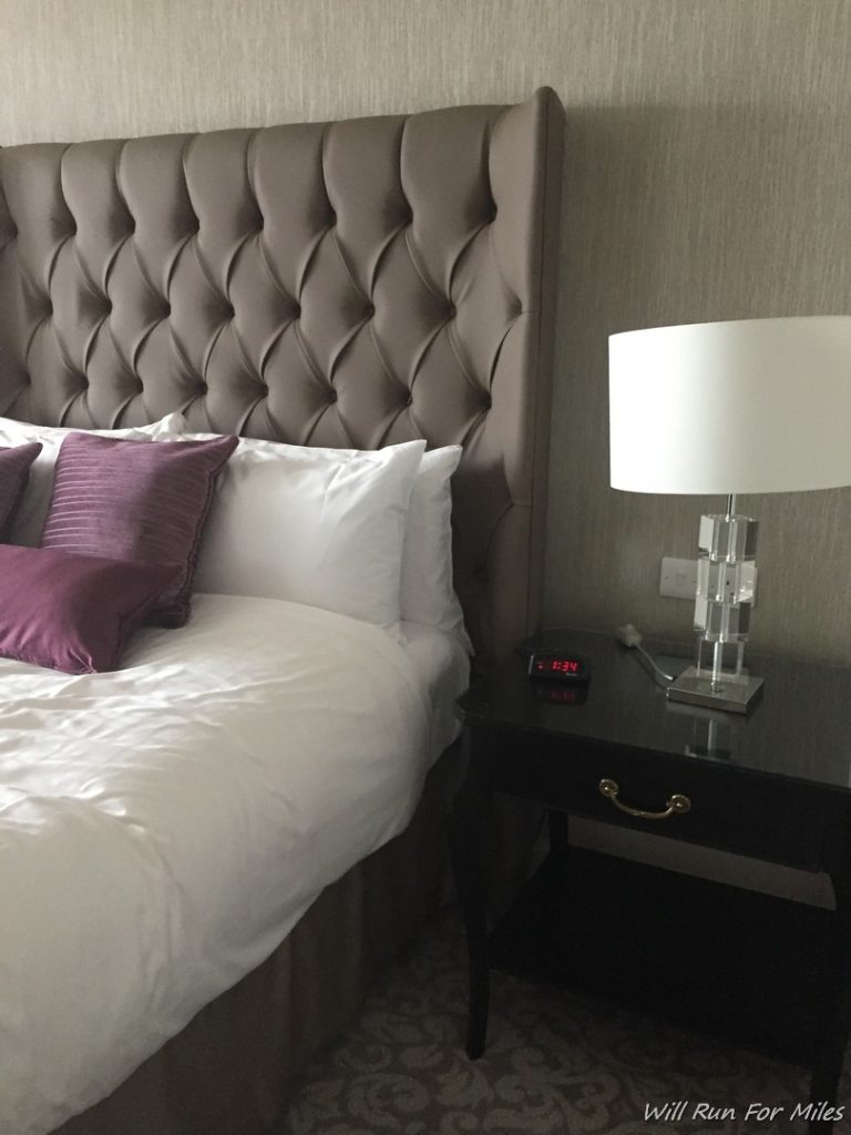 a bed with a lamp next to it