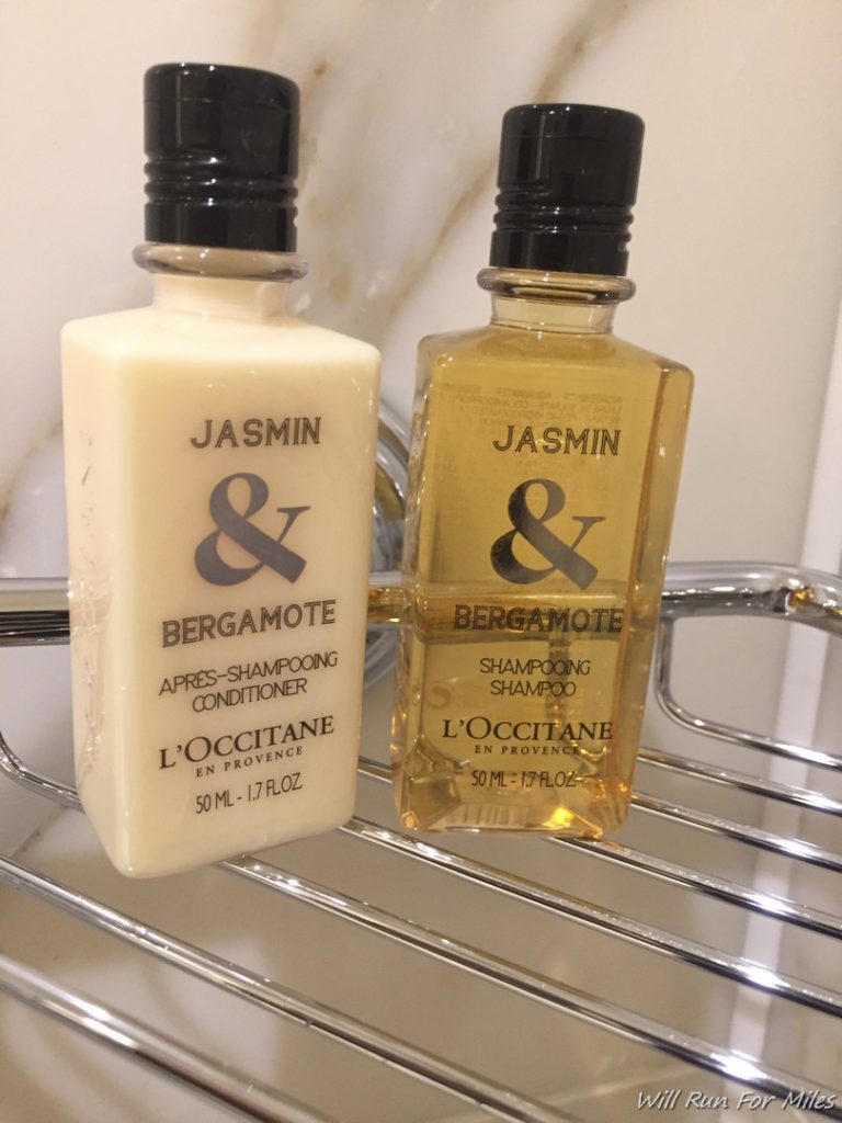a couple of bottles of shampoo on a metal shelf