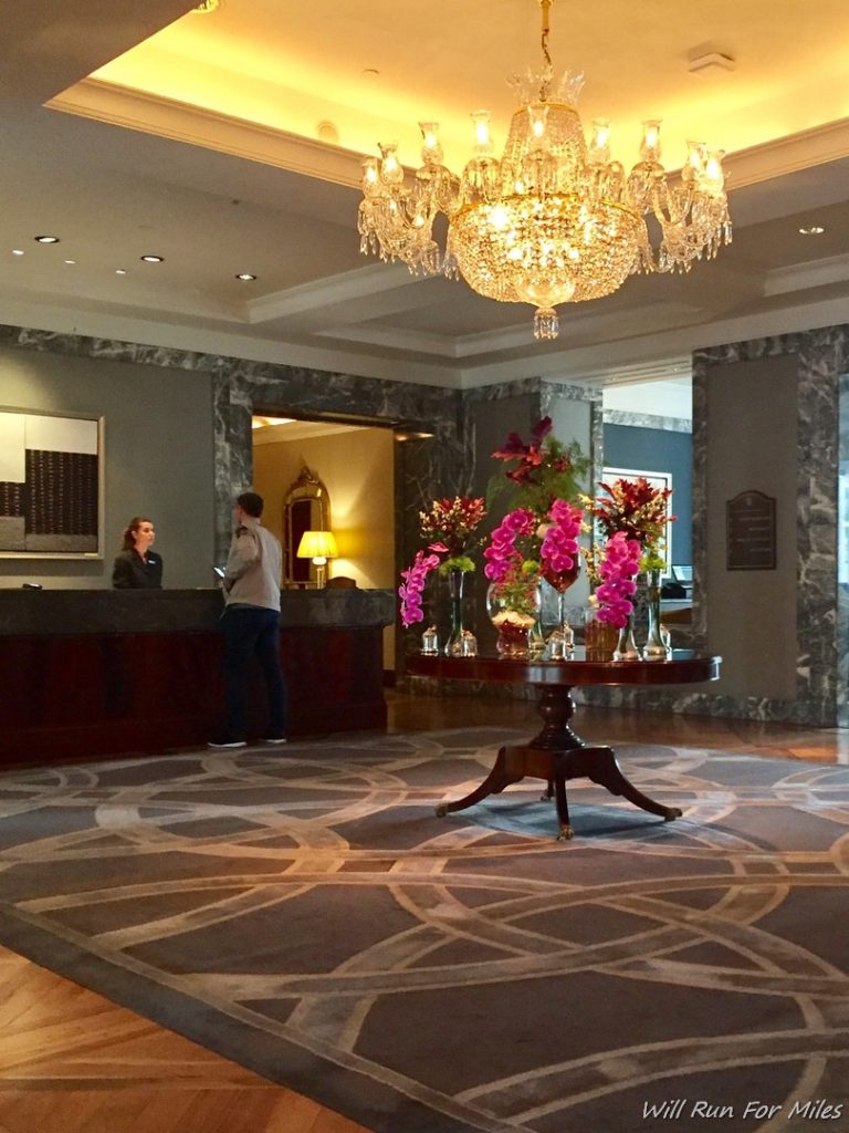 a lobby with a chandelier and flowers