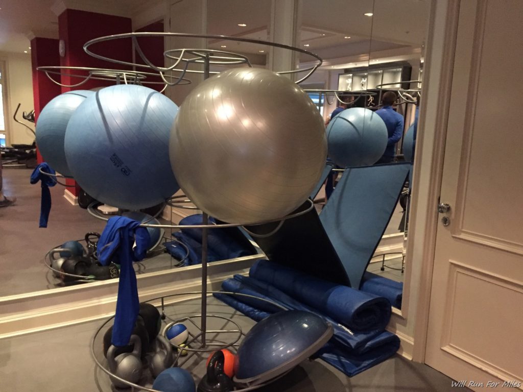 a group of exercise balls on a rack