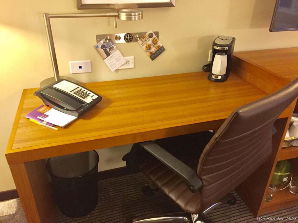 a desk with a telephone and a chair