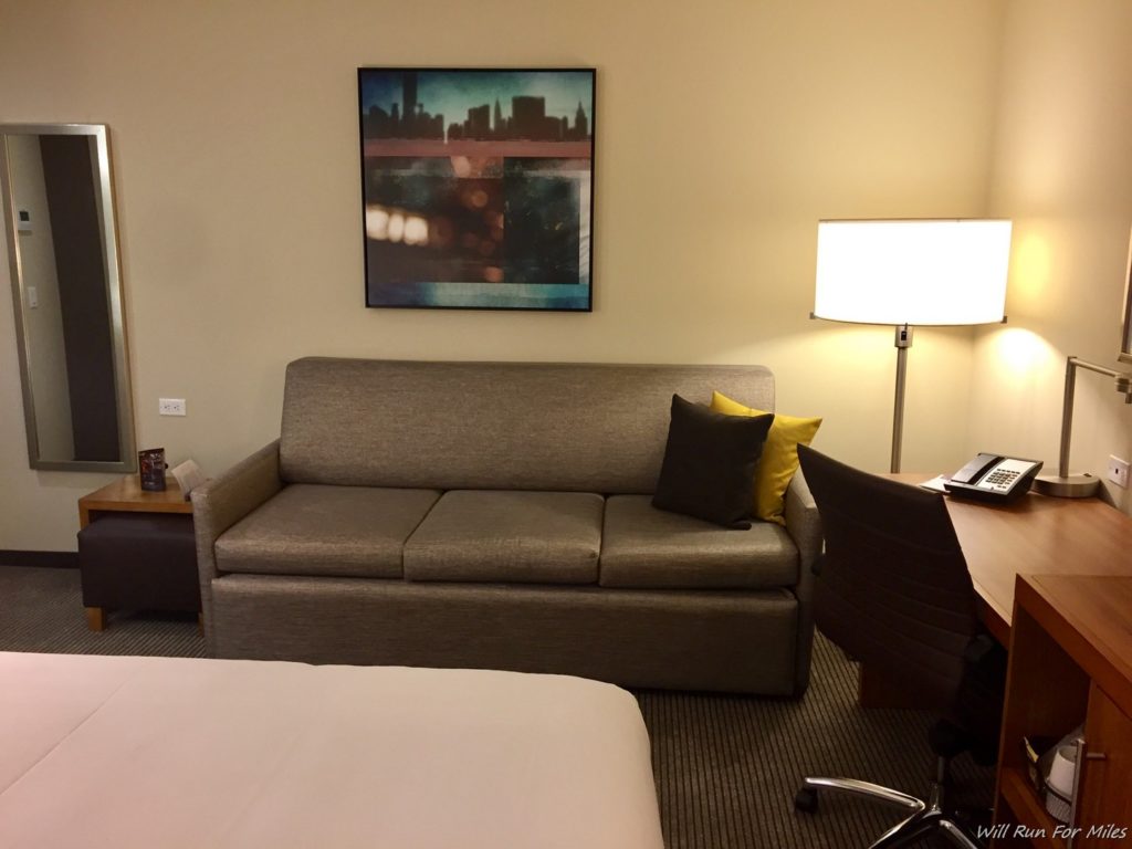 a couch and lamp in a hotel room