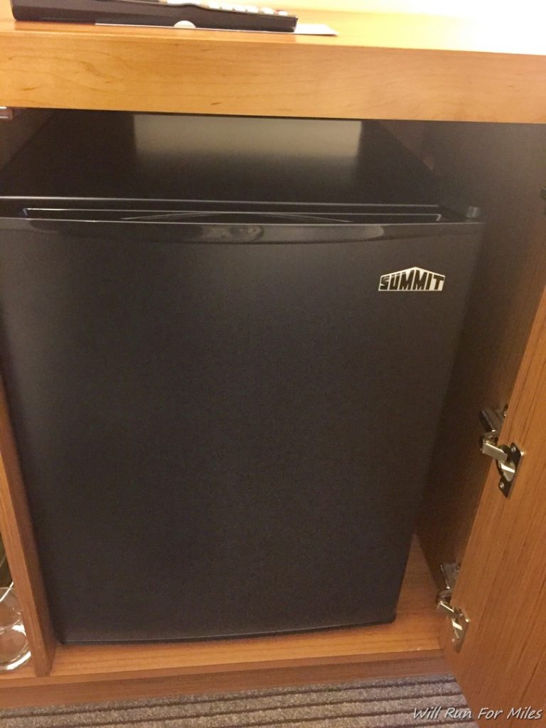 a black refrigerator in a cabinet