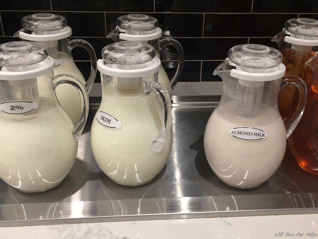 a group of glass jugs with white liquid in them
