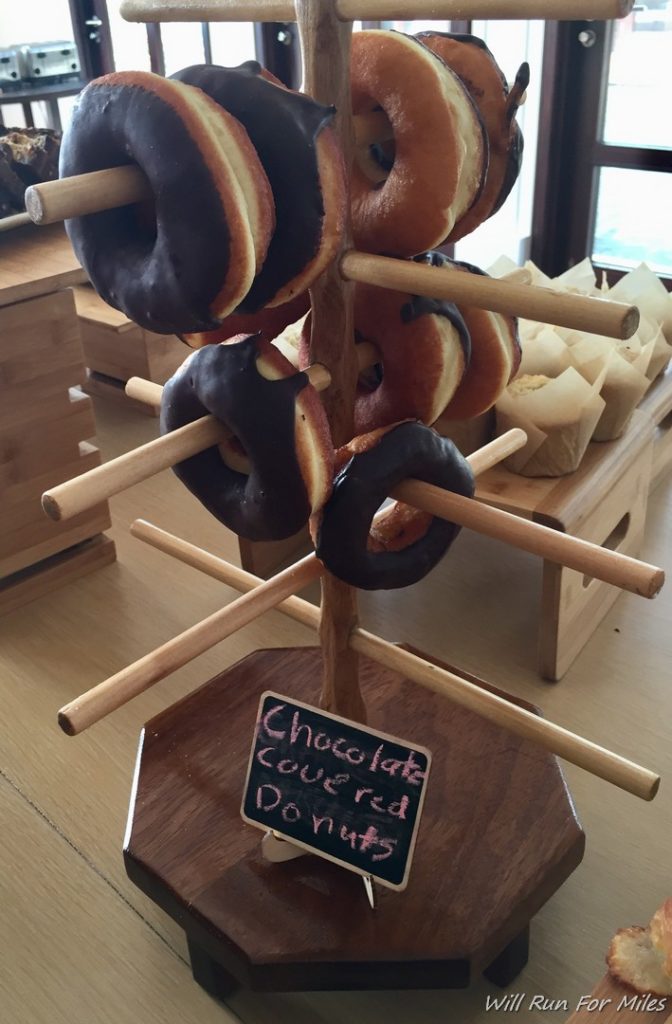 a chocolate covered donuts on a stand