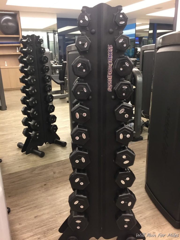 a black weight rack with weights