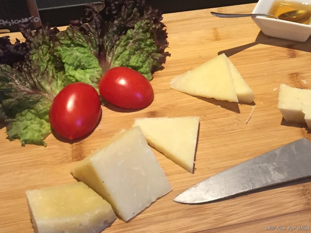 a cheese and tomatoes on a cutting board