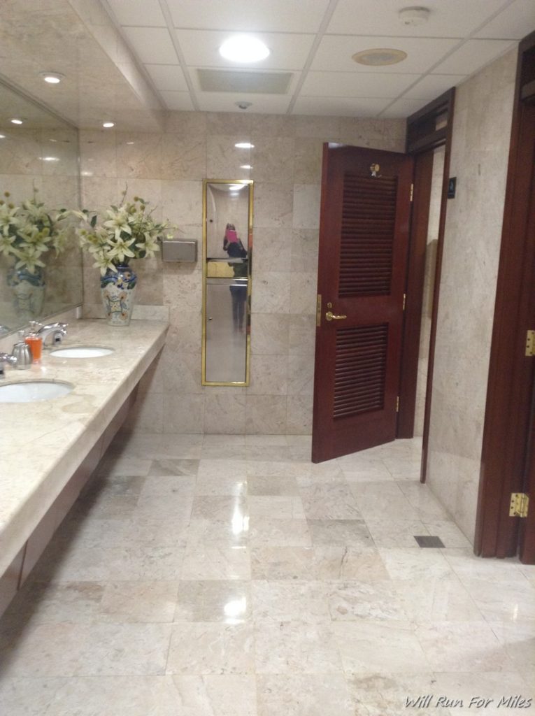 a bathroom with marble tiles and a door