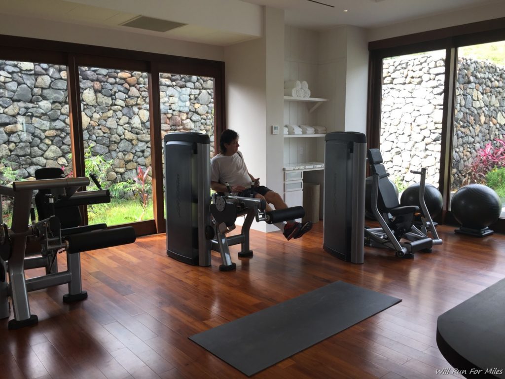 a man on exercise equipment in a room