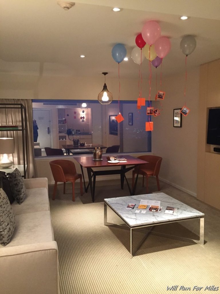 a living room with a table and balloons