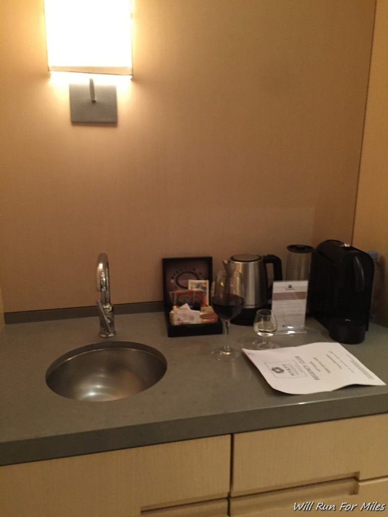 a sink and coffee maker on a counter