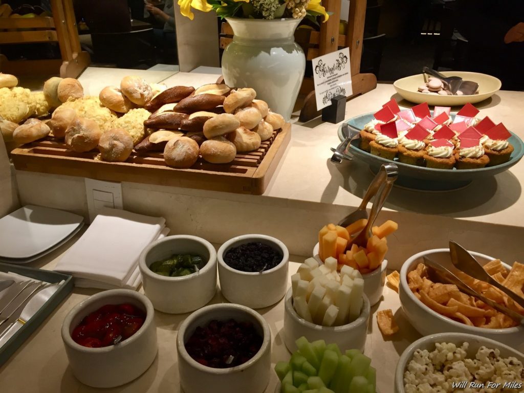 a buffet table with food and fruit