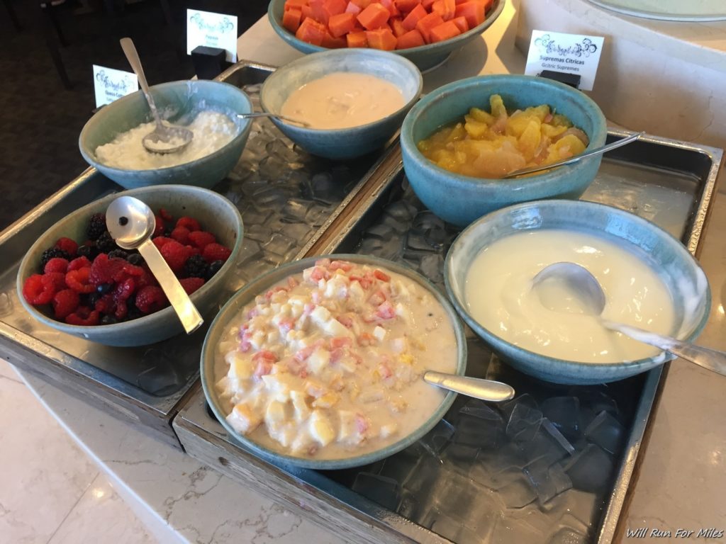 a group of bowls of fruit and yogurt