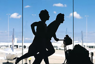 a man pushing a woman in an airport