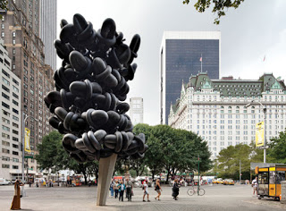 a statue of a tree in a city