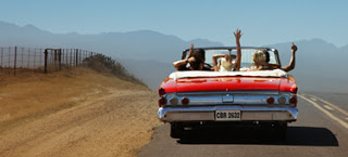 a group of people in a convertible car