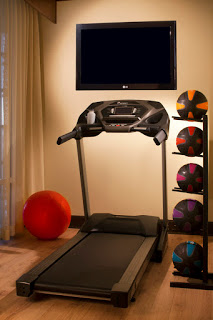 a treadmill and a tv on the wall