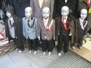 a group of mannequins dressed up in suits