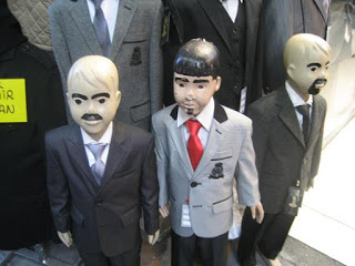a group of mannequins wearing suits