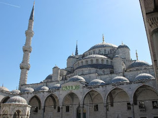 a large building with many arches with Sultan Ahmed Mosque in the background