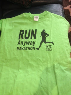 a green shirt with a running figure on it