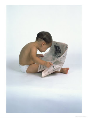 a baby reading a newspaper